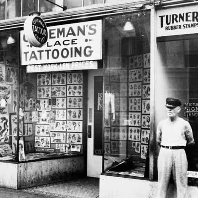 Black and White Old Photo Cap Coleman Standing in Front of The Tattoo Studio