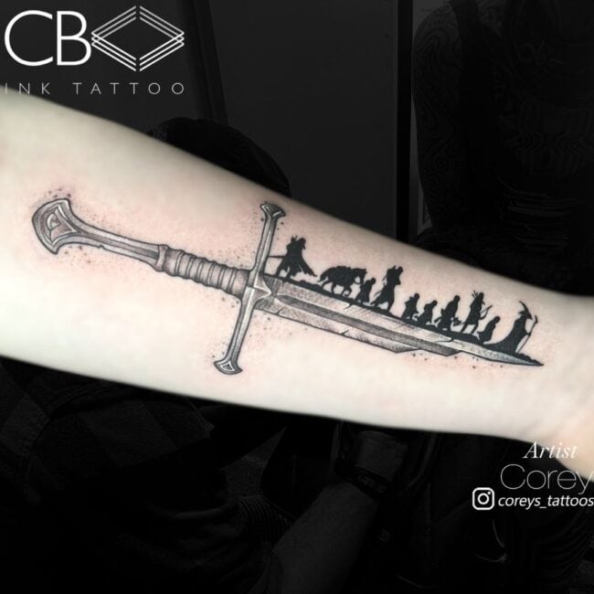 Corey Tattoo Artist Lord of the Rings The Fellowship of the Ring Shadows on Broken Sword Black and White Realism Arm Tattoo