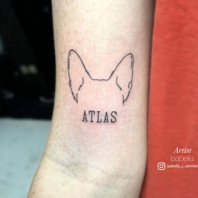 Isabella Tattoo Artist Fine Line Black and Grey Dog Ears and Writing Atlas Arm Tattoo