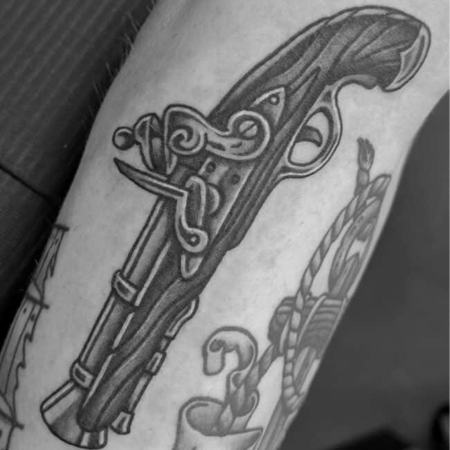 Black and Grey Realism Pirate Weapon Pistol with Sharp Part Intricate Details Trigger-Guard Hammer Jaws Frizzen Pan Forearm Tattoo