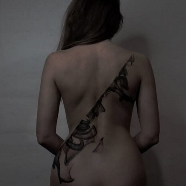 Bold Blackwork Spine Ink Design Abstract Geometrical Smoke Element Cascading Down Symbolising Strength and Resilience Back Tattoo