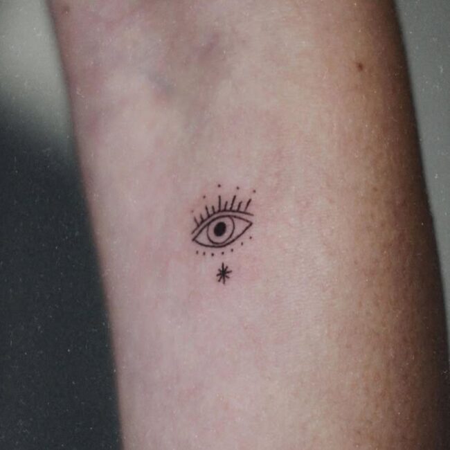 Fine Line Minimalist The Evil Eye With Little Star Below Forearm Tattoo