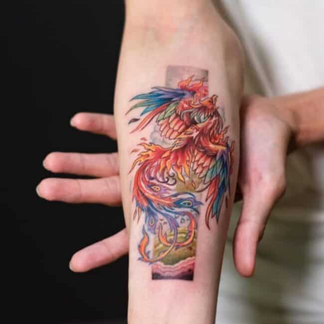Colour Cartoon Anime Whole Body Phoenix Pointed Beak Glowing Eye Crest Wings Tail Feathers Detailed Background Elements Forearm Tattoo