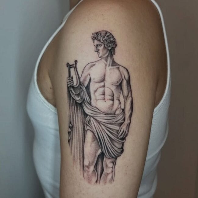 Black and Grey Realism Apollo Tattoo Laurel Wreath Lyre Cloth Element Fierce Arm Tattoo