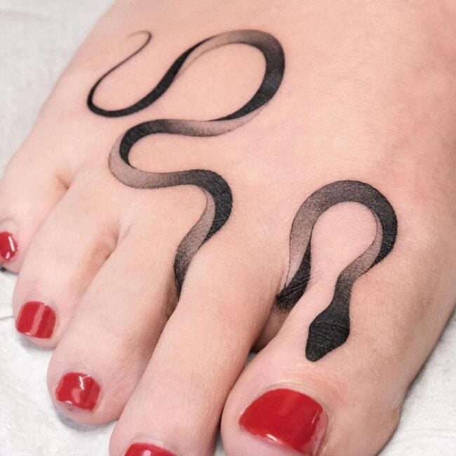 Black and Grey Fine Line Minimalist Sleek Snake Elegant Curves Black Head Shading Snake Foot Tattoo