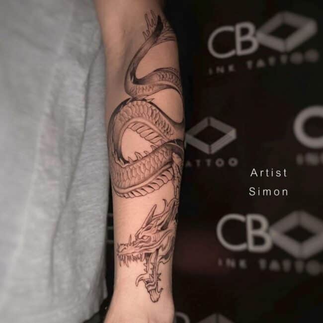 Simon Tattoo Artist Black and Grey Traditional Fine Line Full Body Dragon Sharp Claws Paws Teeth Horns Detailed Belly Eyes Nose Scales Arm Forearm Tattoo