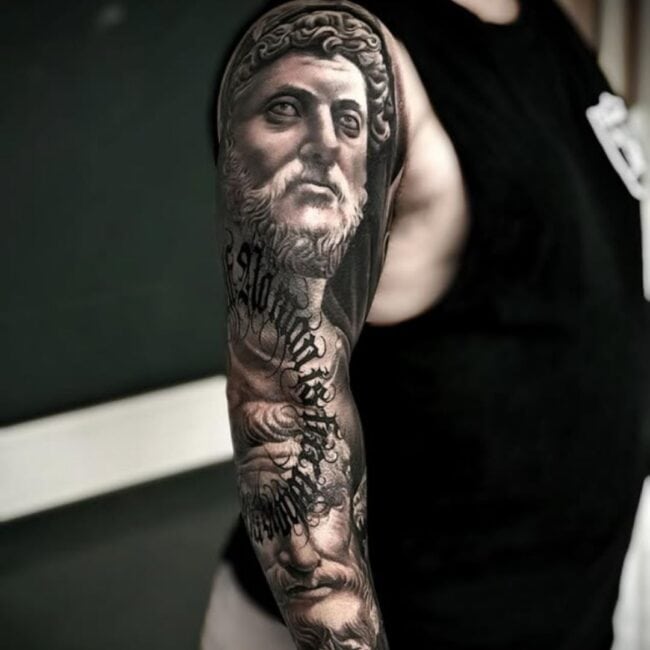 Sunny Tattoo Artist Black and Grey Realism Portrait Tattoo Greek Zeus Detailed Eye Nose Beard Mustache Curled Hair Looking into the Distance Shoulder Arm Sleeve Tattoo