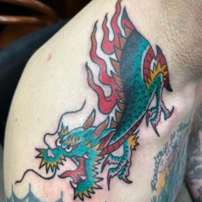 Traditional Colour Bold Lines Half Body Dragon Sharp Teeth Whiskers Claws Paws Horns Scales Burning Flames Fierce Eyes Shoulder Neck Tattoo