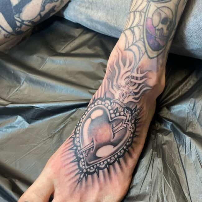 Traditional Scared Heart Shadows Sword Detailed Stabbed Heart Cross Flames Thorns Foot Tattoo